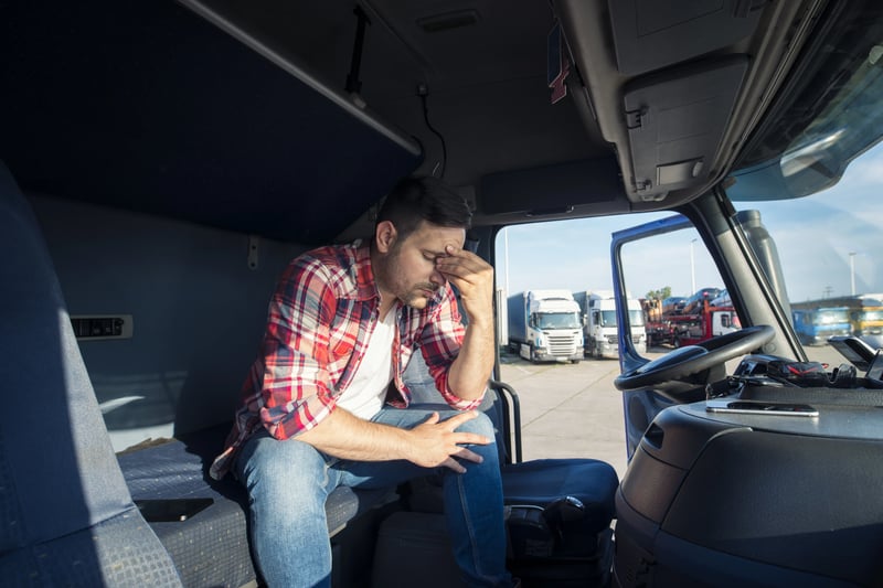 truck-driver-sitting-his-truck-cabin-feeling-worried-upset