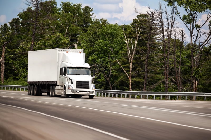 white-truck-with-white-conteiner-road-summer